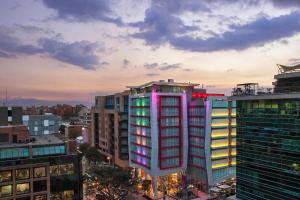 a tall building with colorful windows in a city at Four Points By Sheraton Bogota in Bogotá