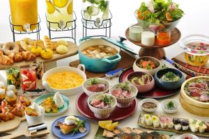 a table topped with lots of different types of food at OMO7 Kochi by Hoshino Resorts in Kochi