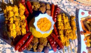 a tray of food with an egg and sausage and peppers at Les Jardins Yasmina Bin el-Ouidane in Bine el Ouidane