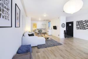 a living room with a white couch and a table at bHOTEL Nikke - 2BR Apt for 10ppl near Hondori Shopping in Hiroshima