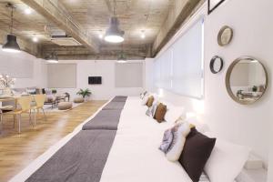 a living room with a long couch and a mirror at b hotel Nikke - 1BR Apt for 10ppl near Hondori Shopping in Hiroshima