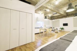 a living room with white cabinets and a dining room at b hotel Nikke - 1BR Apt for 10ppl near Hondori Shopping in Hiroshima