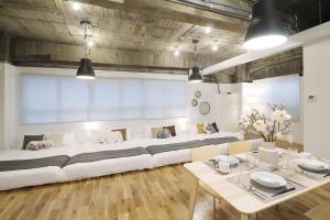 a large white couch in a room with a table at b hotel Nikke - 1BR Apt for 10ppl near Hondori Shopping in Hiroshima