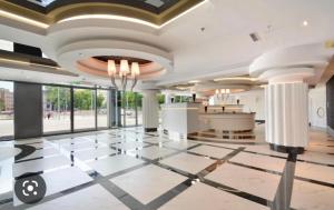 a lobby with a large room with a large ceiling at Hanza Tower GRAND HOTEL Pool Jacuzzi Sauna in Szczecin