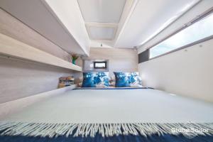 a bedroom with a large bed and a window at Florida Sail - Custom Sail Experiences in St Pete Beach