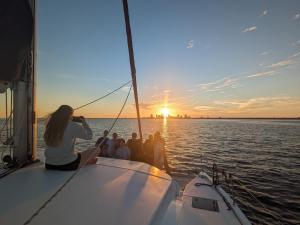 a group of people on a sail boat at sunset at Florida Sail - Custom Sail Experiences in St Pete Beach