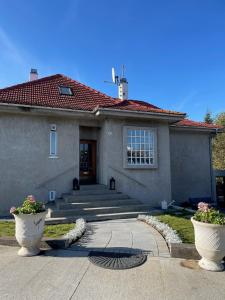 a house with two flower pots in front of it at Casa Dísa - Dreams, A Boutique Guesthouse in Reykjavik City`s Central Park and Botanical Garden in Laugardalur, Hot-Spring-Valley in Reykjavík
