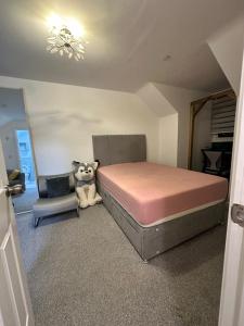a bedroom with a bed and a chair at Modern en-suite spacious room near Deansgate manchester city in Manchester