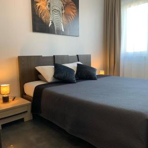 een slaapkamer met een bed en een foto van een olifant bij Central Park Apartment in Łódź