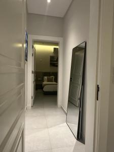 a hallway with a mirror and a bed in a room at Al majdiah village قرية الماجدية in Riyadh