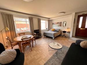 a living room with a bed and a table at Casa Dísa - Apartments A Boutique Guesthouse in Reykjavik City`s Central Park and Botanical Garden in Laugardalur, Hot-Spring-Valley in Reykjavík