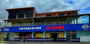 a building with a blue and red sign on it at Pousada Oliveira in Florianópolis