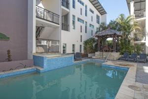 a swimming pool in front of a building at Paradiso Resort by Kingscliff Accommodation in Kingscliff