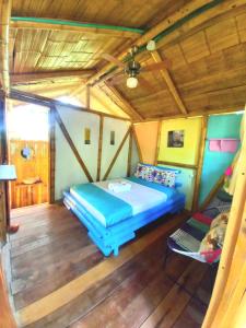 a bedroom with a bed and a chair in a room at Avani del desierto in Villavieja