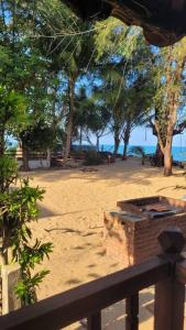 a view of a beach with trees and the ocean at Rumah Aggrek@Zaki’s Residence, Marang, Terengganu in Kampong Ru Lima