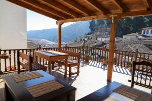 a patio with a table and chairs on a balcony at DD Villa in Berat