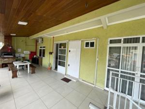 a porch of a house with a table and doors at Pousada Oliveira in Florianópolis