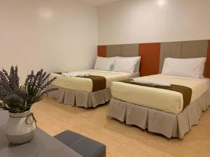 Postel nebo postele na pokoji v ubytování ILOILO GRAND HOTEL