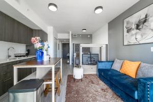 a kitchen and living room with a blue couch at Devereaux Miami Luxury One-Bedroom and Studios in Miami