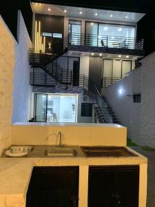 ein großes Haus mit einem Waschbecken und einer Treppe in der Unterkunft Apartamento de descanso in La Dorada
