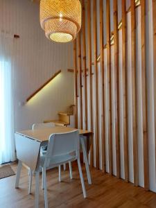 a dining room with a table and chairs and a chandelier at Casas da Chaminé Eco Country Lodge in Nordeste