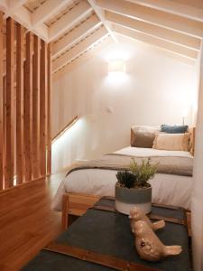 a bedroom with a bed and a table with a plant at Casas da Chaminé Eco Country Lodge in Nordeste