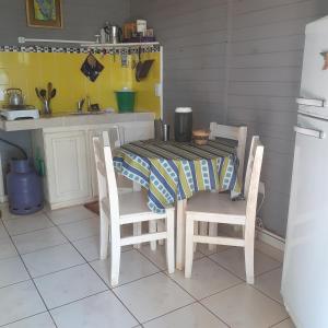 a kitchen with a table and two chairs and a table and a table at Espacio Benignia in Puerto Libertad
