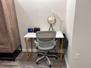 an office with a desk with a chair and a lamp at Luxurious Basement Guest Suite in Elkridge in Elkridge