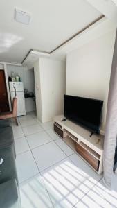 a living room with a flat screen tv on the wall at Apartamento Home Pratice in São Luís