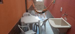 een kamer met een tafel en stoelen en een wastafel bij Pousada Exuberance in Diadema
