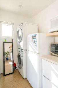 a kitchen with a washer and dryer in a room at Tropical Oasis On The Water Crown Point in San Diego