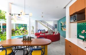 a kitchen and living room with a table and chairs at Villa Ungava in Seminyak