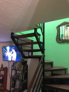 A television and/or entertainment centre at Hostel Tu Espacio RE - Casa cerca del Aeropuerto