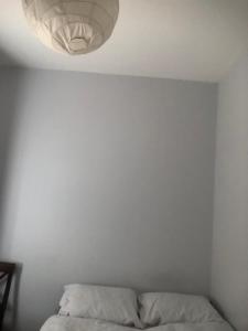 a white room with a bed and a ceiling at Single room in willesden in London