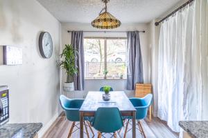 a dining room with a table and blue chairs at Spacious 1 Bed + Studio // Free Parking // Zen Patio in Seattle