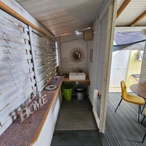 a bathroom with a sink and a toilet in a house at L'Improviste atypique pour une pause détente in Le François