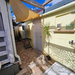 an outside view of a house with a garage at L'Improviste atypique pour une pause détente in Le François