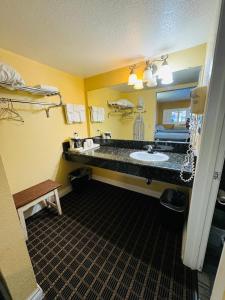 Baño del hotel con lavabo y espejo en Mount Whitney Motel, en Lone Pine
