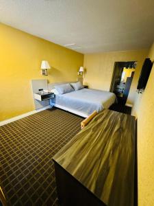 a hotel room with a bed and a tv at Mount Whitney Motel in Lone Pine