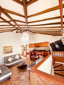 a living room with a couch and a tv at BALCON DE CHIE in Villa de Leyva