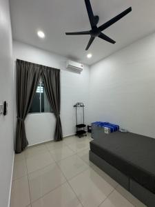 a bedroom with a bed and a ceiling fan at 9 Homestay - Feel like home . in Muar