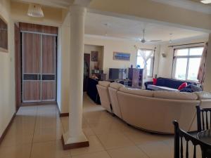 a living room with a couch and a column at Serena Beach View Apartment in Mombasa