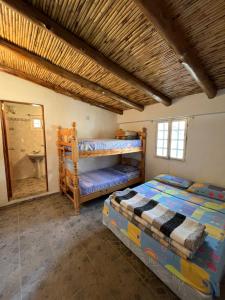 a bedroom with two bunk beds and a mirror at Mi casita de Los Andes in San Rafael