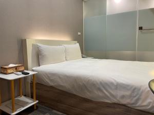 Postel nebo postele na pokoji v ubytování 藝築文旅-昆明館Artinn Kunming