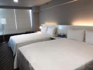 Postel nebo postele na pokoji v ubytování 藝築文旅-昆明館Artinn Kunming