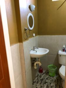 a bathroom with a sink and a toilet at 1 Bedroom Apartment in Curepe