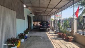 ein Auto, das in einem Gebäude mit Pflanzen geparkt ist in der Unterkunft Nhà nghỉ Hồng Vân in Phan Rang