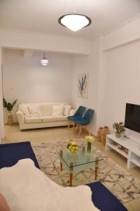 a living room with a couch and a table at Citrus dream apartment in Athens
