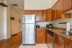 a kitchen with wooden cabinets and a stainless steel refrigerator at Bright & Charming Loft #3 in Halifax