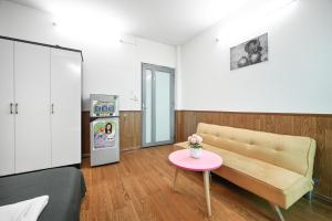 a living room with a couch and a table at Cali Homestay in Ho Chi Minh City